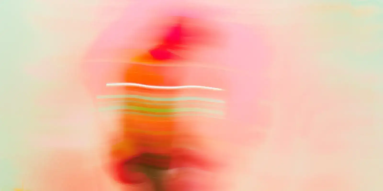 Blurred figure in motion leaving pink and mint light trails