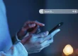 Person typing a question into a search bar on a smartphone