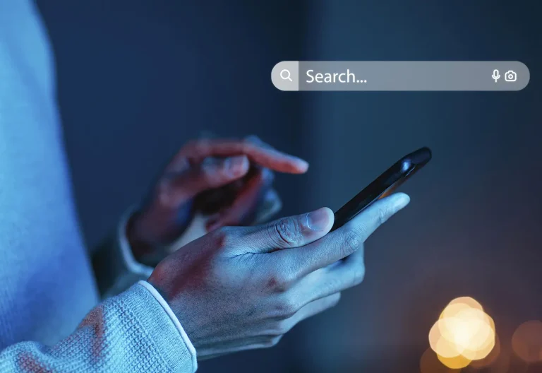Person typing a question into a search bar on a smartphone