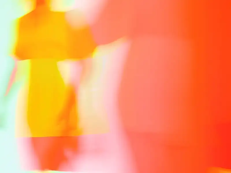 Long-exposure photograph: yellow and orange shapes in motion over mint